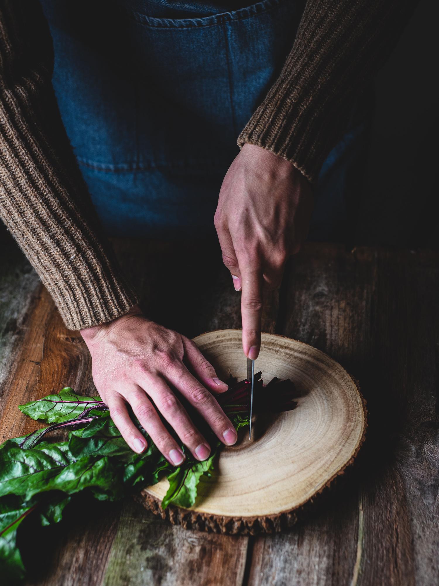 Close-up of seasoned hands preparing herbs